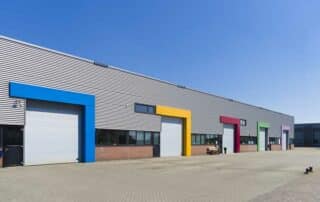 Modern industrial building with colorful borders around their loading dock.