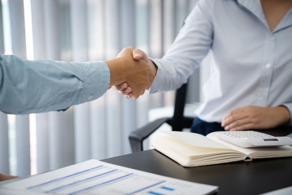 Businessman shaking hands successful making a deal. mans handshake. Business partnership meeting concept.